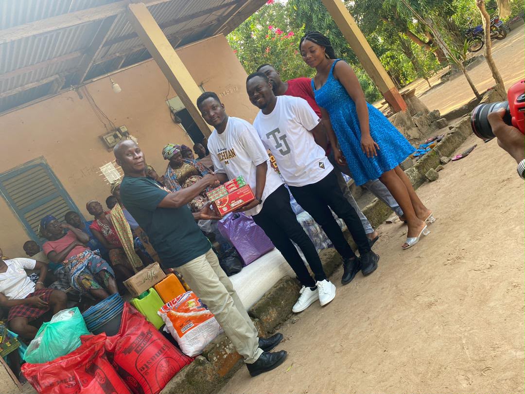 Foundation representatives presenting essential supplies during a community outreach